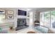 Comfortable living room with a fireplace, modern furnishings, and access to a private outdoor balcony area at 2715 Selwyn Ave # 36, Charlotte, NC 28209