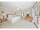 Airy main bedroom with neutral tones, ceiling fan, and sliding glass door to a patio at 2715 Selwyn Ave # 36, Charlotte, NC 28209