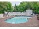 Enjoy community pool access with lounge chairs and lush green trees at 2715 Selwyn Ave # 36, Charlotte, NC 28209