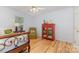 Comfortable bedroom with hardwood floors, a ceiling fan, a red cabinet and a chair at 2906 Chapman Cir, Rock Hill, SC 29732