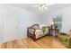 Cozy bedroom featuring hardwood floors, a ceiling fan, and a classic bed with a decorative headboard at 2906 Chapman Cir, Rock Hill, SC 29732