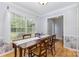Sunny dining area with hardwood floors, wainscoting and a large window overlooking the backyard at 2906 Chapman Cir, Rock Hill, SC 29732