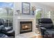 Cozy fireplace with a marble surround, flanked by windows offering serene views at 2906 Chapman Cir, Rock Hill, SC 29732
