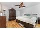 Spacious bedroom with hardwood floors, neutral walls, ceiling fan and a large decorative armoire at 2906 Chapman Cir, Rock Hill, SC 29732
