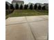 View of backyard featuring a concrete patio, lawn, and black metal fence at 3022 Burnello Ct, Iron Station, NC 28080