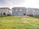 Backyard view featuring a green lawn, fence, patio, and exterior of the home at 3022 Burnello Ct, Iron Station, NC 28080