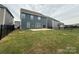 Backyard with concrete patio, lawn, and black metal fence surrounding the property at 3022 Burnello Ct, Iron Station, NC 28080