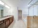 Bathroom featuring granite countertops, and sinks, tiled shower, and soaking tub at 3022 Burnello Ct, Iron Station, NC 28080