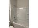 Well-lit bathroom featuring a tub-shower combo with built-in shelves at 3022 Burnello Ct, Iron Station, NC 28080