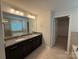 Bathroom featuring a dual sink vanity with granite counters and tile floors at 3022 Burnello Ct, Iron Station, NC 28080