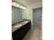 Double sink bathroom with granite countertop and a tub-shower at 3022 Burnello Ct, Iron Station, NC 28080