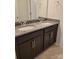 Bathroom vanity featuring double sinks with granite countertops and dark cabinetry at 3022 Burnello Ct, Iron Station, NC 28080