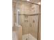 Shower with glass door, tiled walls, and built-in shelves showcasing stylish design at 3022 Burnello Ct, Iron Station, NC 28080