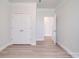 Bright bedroom with crown molding, a closet with double doors and wood-look flooring at 3022 Burnello Ct, Iron Station, NC 28080