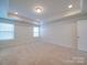 Bright bedroom with tray ceiling, neutral carpet, and double windows allowing for ample natural light at 3022 Burnello Ct, Iron Station, NC 28080