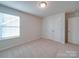 Bedroom featuring neutral walls, carpet, closet, and a large window at 3022 Burnello Ct, Iron Station, NC 28080