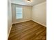 Bedroom with light-colored wood floors, white trim and a window with blinds at 3022 Burnello Ct, Iron Station, NC 28080
