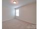 This bedroom features neutral walls and carpet with a bright window at 3022 Burnello Ct, Iron Station, NC 28080