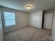 Bright bedroom features carpeted flooring, natural light, and closet at 3022 Burnello Ct, Iron Station, NC 28080