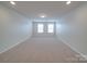 Large bonus room with two windows for natural light and neutral carpet at 3022 Burnello Ct, Iron Station, NC 28080