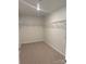 Walk-in closet with built-in wire shelving and neutral carpet at 3022 Burnello Ct, Iron Station, NC 28080