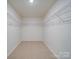 Walk-in closet with carpeted floors and wire shelving, offering ample storage space at 3022 Burnello Ct, Iron Station, NC 28080