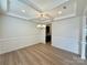 Formal dining room with tray ceiling, chandelier, and elegant wall paneling, great for entertaining at 3022 Burnello Ct, Iron Station, NC 28080