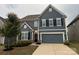 Charming two-story home with a two-car garage and manicured landscaping at 3022 Burnello Ct, Iron Station, NC 28080