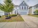 Charming two-story home with a well-maintained lawn, inviting curb appeal, and a two-car garage at 3022 Burnello Ct, Iron Station, NC 28080