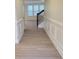 Inviting hallway with wainscoting detail and staircase leading upstairs at 3022 Burnello Ct, Iron Station, NC 28080