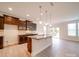 Modern kitchen featuring dark cabinets, stainless appliances, granite countertops, and a large island at 3022 Burnello Ct, Iron Station, NC 28080