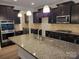 Spacious kitchen island, granite countertops and stainless steel appliances at 3022 Burnello Ct, Iron Station, NC 28080