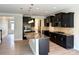 Stylish kitchen with a large island, granite countertops, dark wood cabinets, and stainless steel appliances at 3022 Burnello Ct, Iron Station, NC 28080