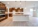 Stylish kitchen featuring a center island, stainless steel appliances, and dark wood cabinetry at 3022 Burnello Ct, Iron Station, NC 28080