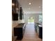 Modern kitchen features stainless steel appliances, dark cabinetry, and granite countertops with exterior door access at 3022 Burnello Ct, Iron Station, NC 28080
