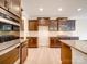 Modern kitchen with dark cabinets, granite countertops, tile backsplash, and stainless steel appliances at 3022 Burnello Ct, Iron Station, NC 28080