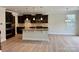 An open concept kitchen and living area with a large island, modern lighting, and ample space at 3022 Burnello Ct, Iron Station, NC 28080