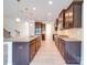 Spacious kitchen with dark cabinets, granite countertops, stainless appliances, and light-colored flooring at 3022 Burnello Ct, Iron Station, NC 28080