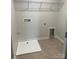 Functional laundry room with tile flooring, storage shelf and hookups at 3022 Burnello Ct, Iron Station, NC 28080