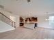 Open-concept space with modern staircase, wood-look flooring, and a view of the kitchen at 3022 Burnello Ct, Iron Station, NC 28080