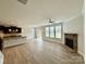 Spacious living area with a fireplace, a ceiling fan, and lots of natural light streaming through the windows at 3022 Burnello Ct, Iron Station, NC 28080