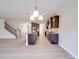Open floor plan showcases kitchen with dark cabinets and island open to living area with stairway at 3022 Burnello Ct, Iron Station, NC 28080