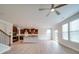 Open-concept living space with wood-look flooring, staircase, and a view into the modern kitchen at 3022 Burnello Ct, Iron Station, NC 28080