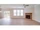 Living room features a stone fireplace, large windows, and sliding glass doors to backyard at 3022 Burnello Ct, Iron Station, NC 28080