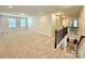 Spacious loft area with neutral carpet, recessed lighting, and staircase with dark wood railing at 3022 Burnello Ct, Iron Station, NC 28080