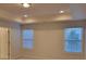 Main bedroom with tray ceilings, two windows and neutral carpet at 3022 Burnello Ct, Iron Station, NC 28080
