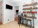 A bar area features custom wood shelving, liquor, and seating at 3049 Stablegate Dr, Gastonia, NC 28052