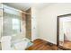 The bathroom has a glass shower, wood look floor and tile accents at 3049 Stablegate Dr, Gastonia, NC 28052