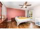 This bedroom features wood floors, neutral wall color, and a ceiling fan at 3049 Stablegate Dr, Gastonia, NC 28052