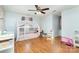 Bright bedroom features wood floors, a ceiling fan, and a charming white canopy bed for a cozy retreat at 3049 Stablegate Dr, Gastonia, NC 28052